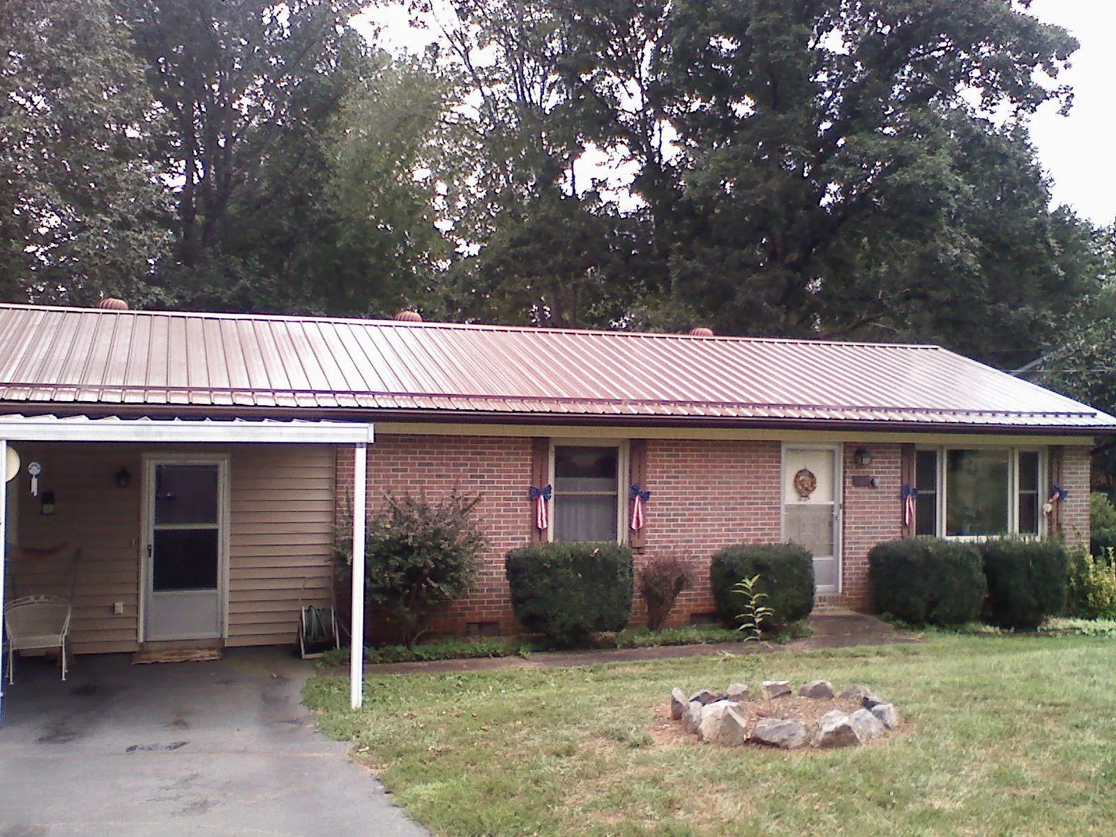 Bronze metal roof and carport on a brick ranch home — Roof Repair work by our crew in Voorhees